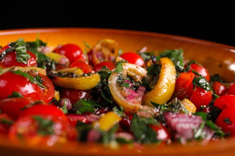Tomato salad with slices of grilled lemon