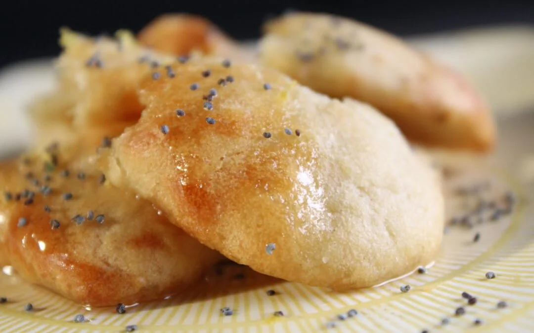 Break bread dipped in agave / lemon syrup and poppy seed
