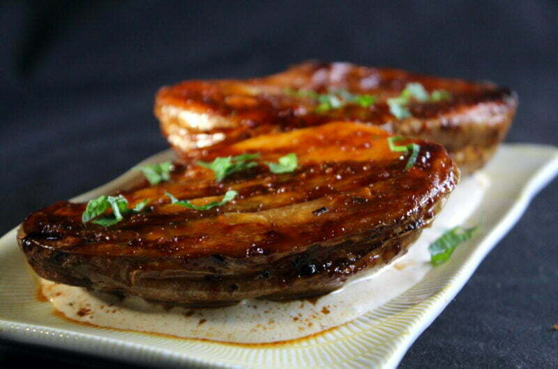 Glazed baked potato from the oven in sweet soy sauce-harissa-tahina