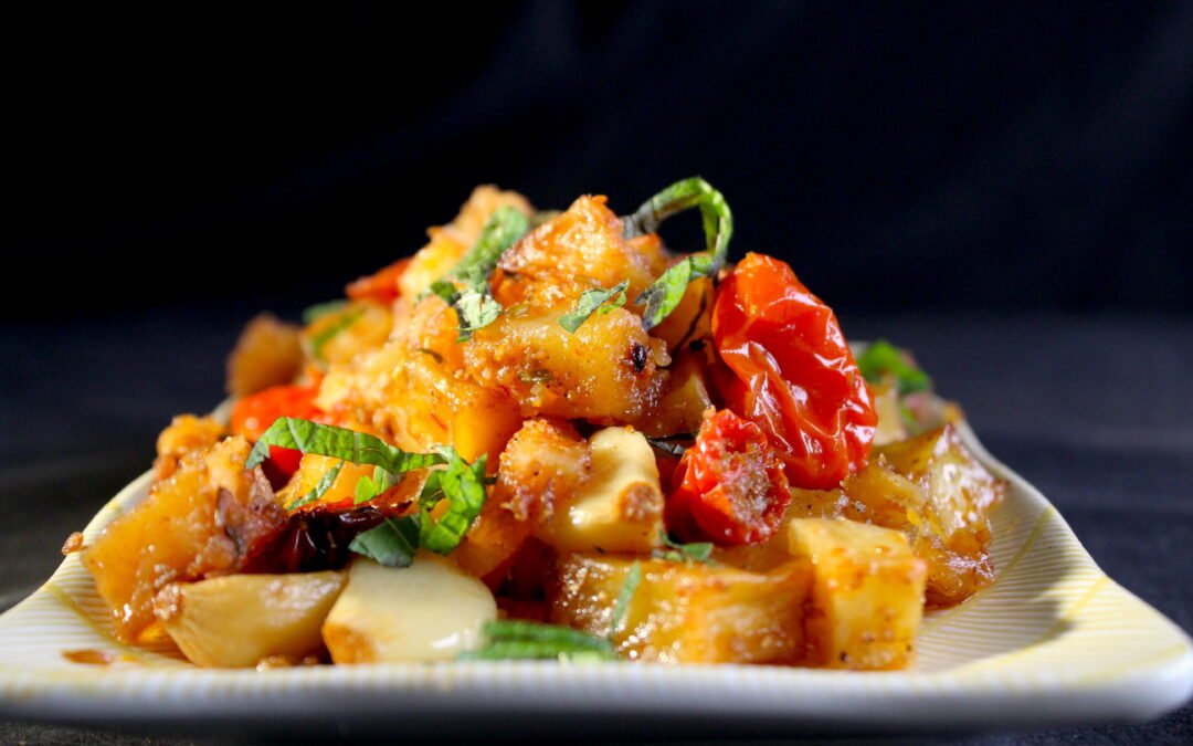 Fresh and spicy potatoes with tomatoes from the oven