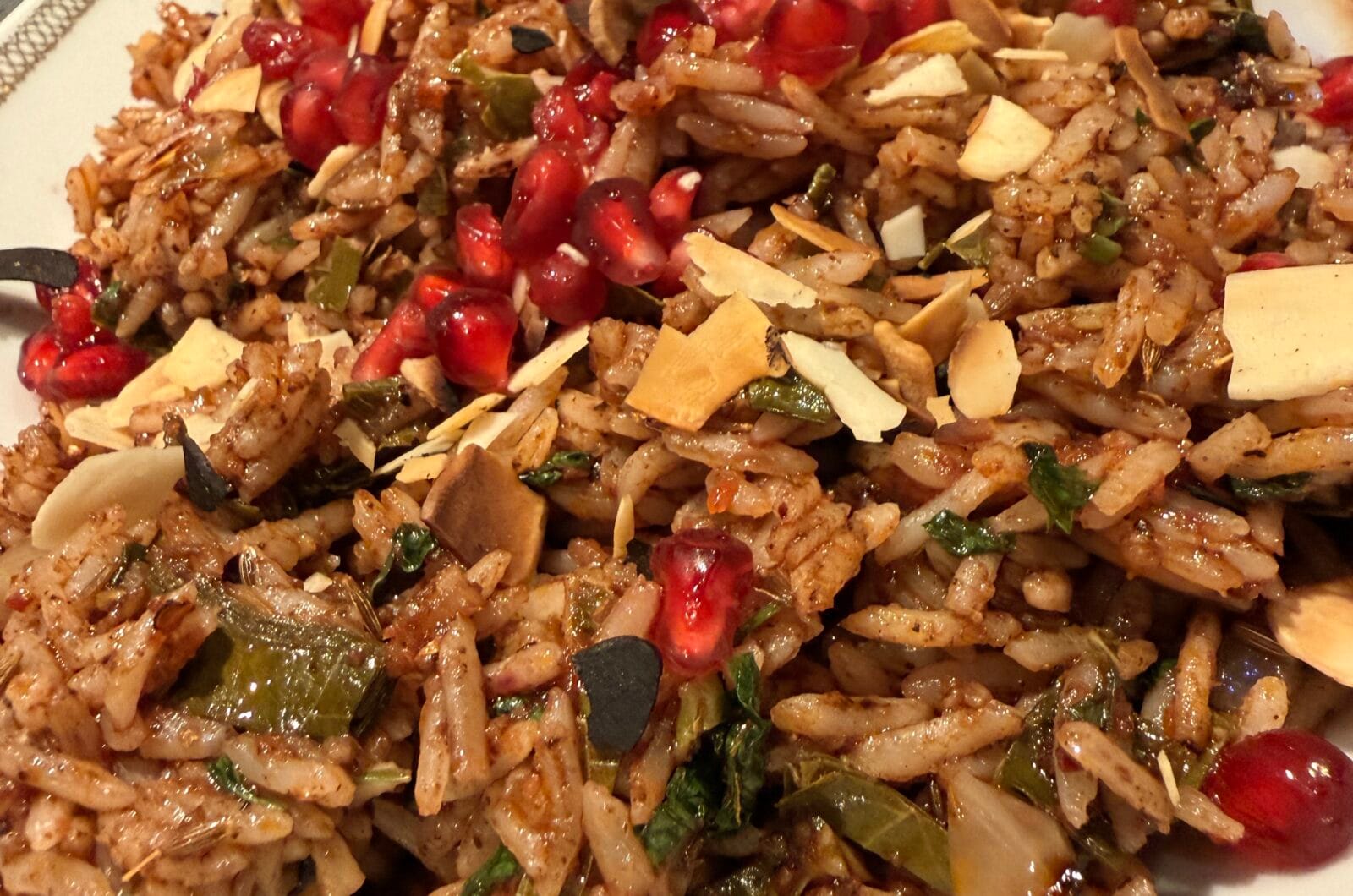 Fried spicy rice with almonds, vine leaves and pomegranate molasses  