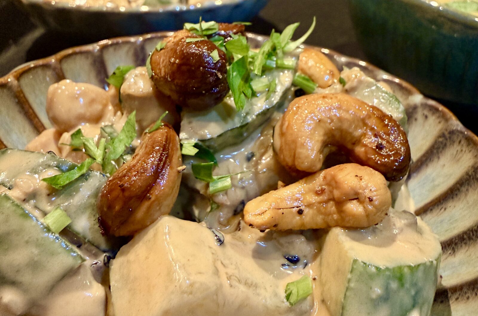 Salade van komkommer, soja/tahina dressing, kikkererwten, cashewnoten, sesamzaad en rode ui